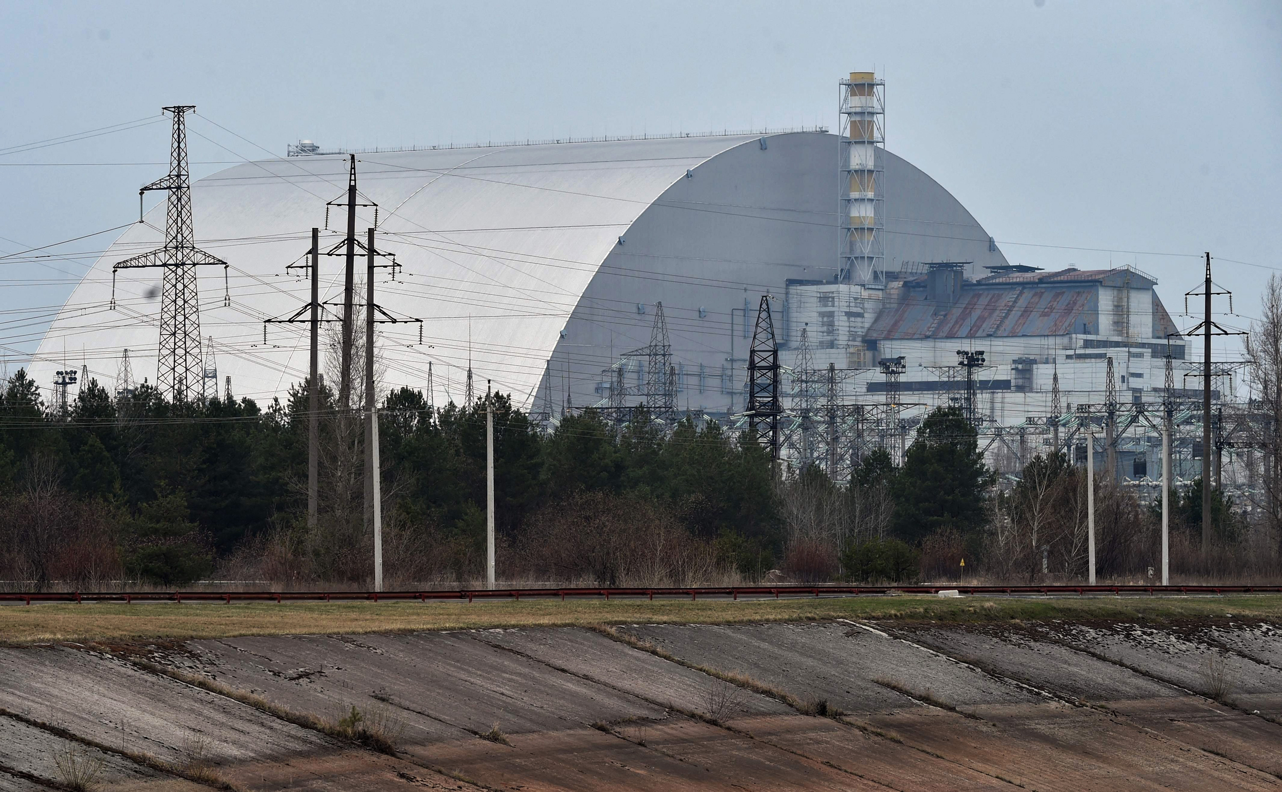 (FILES) A file picture taken on April 13, 2021 shows the giant protective dome built over the sarcophagus covering the destroyed fourth reactor of the Chernobyl Nuclear Power Plant ahead of the upcoming 35th anniversary of the Chernobyl nuclear disaster. - Ukraine announced on February 24 that Russian forces had captured the Chernobyl nuclear power plant after a "fierce" battle on the first day of the Kremlin's invasion of its ex-Soviet neighbour. "After the absolutely senseless attack of the Russians in this direction, it is impossible to say that the Chernobyl nuclear power plant is safe. This is one of the most serious threats to Europe today," said Mykhailo Podolyak, advisor to the chief of the presidential administration. (Photo by Sergei SUPINSKY / AFP) (Photo by SERGEI SUPINSKY/AFP via Getty Images)