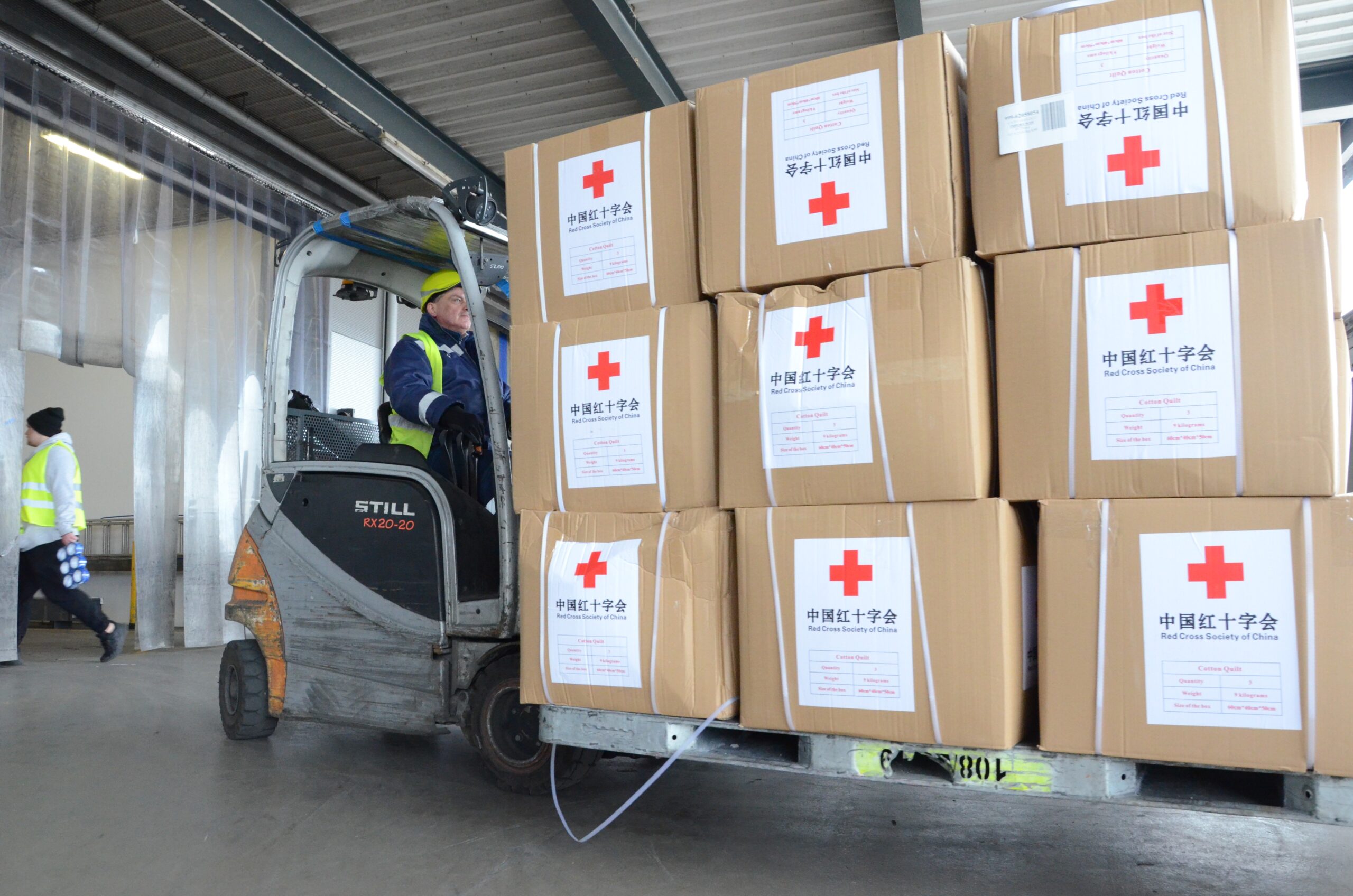 Humanitarian aid supplies sent by the Red Cross Society of China to the Ukrainian Red Cross Society are transported in Warsaw, Poland, March 15, 2022. The Red Cross Society of China announced Monday that it has sent a third batch of emergency humanitarian aid supplies to the Ukrainian Red Cross Society.   The new supplies, including milk powder for children and quilts, left Beijing on Monday and arrived in Warsaw, Poland. They will then be transported to Ukraine. (Photo by Chen Chen/Xinhua via Getty Images)
