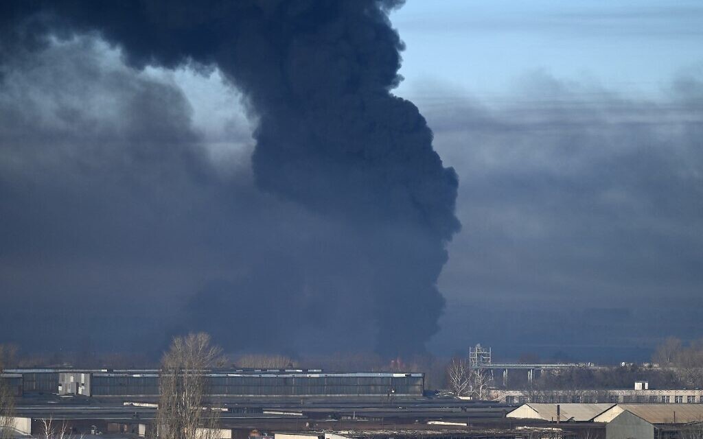 Black smoke rises from a military airport in Chuguyev near Kharkiv  on February 24, 2022. - Russian President Vladimir Putin announced a military operation in Ukraine today with explosions heard soon after across the country and its foreign minister warning a "full-scale invasion" was underway. (Photo by ARIS MESSINIS / AFP)